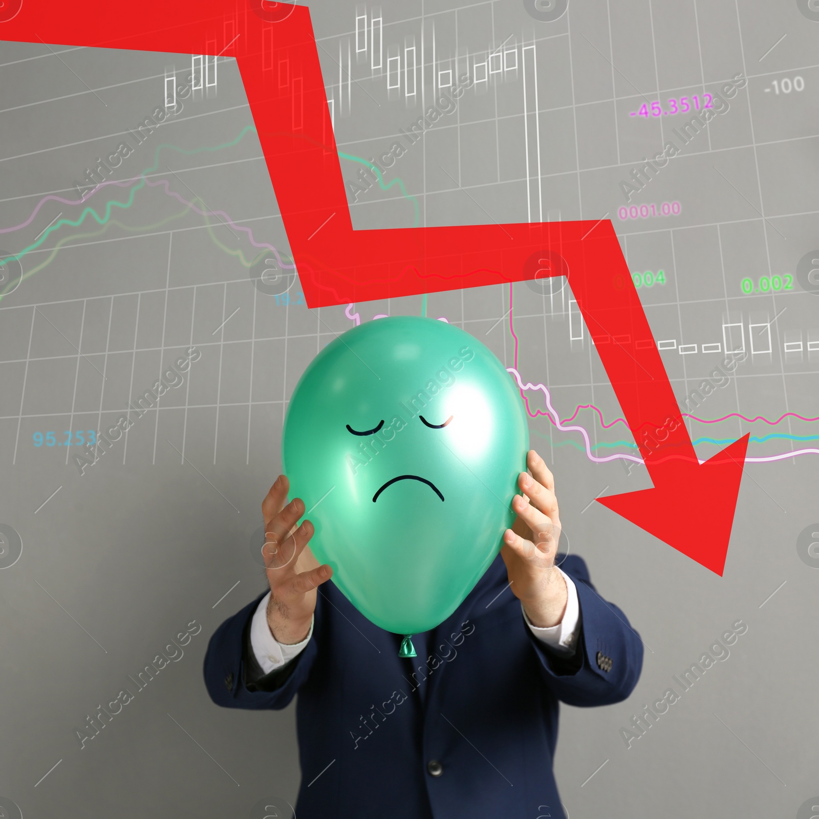 Image of Businessman holding air balloon with drawn sad face and illustration of falling down chart on light grey background. Economy recession concept