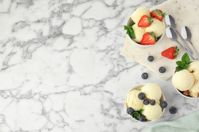 Flat lay composition with delicious vanilla ice cream on marble table. Space for text