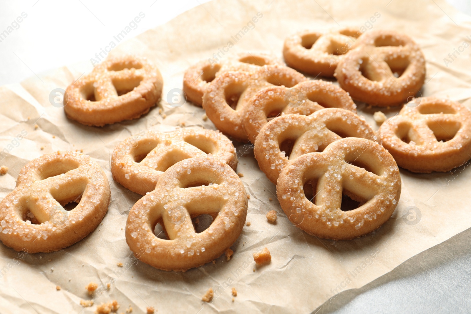 Photo of Paper and tasty Danish butter cookies on table