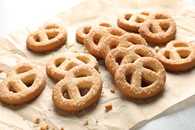 Photo of Paper and tasty Danish butter cookies on table