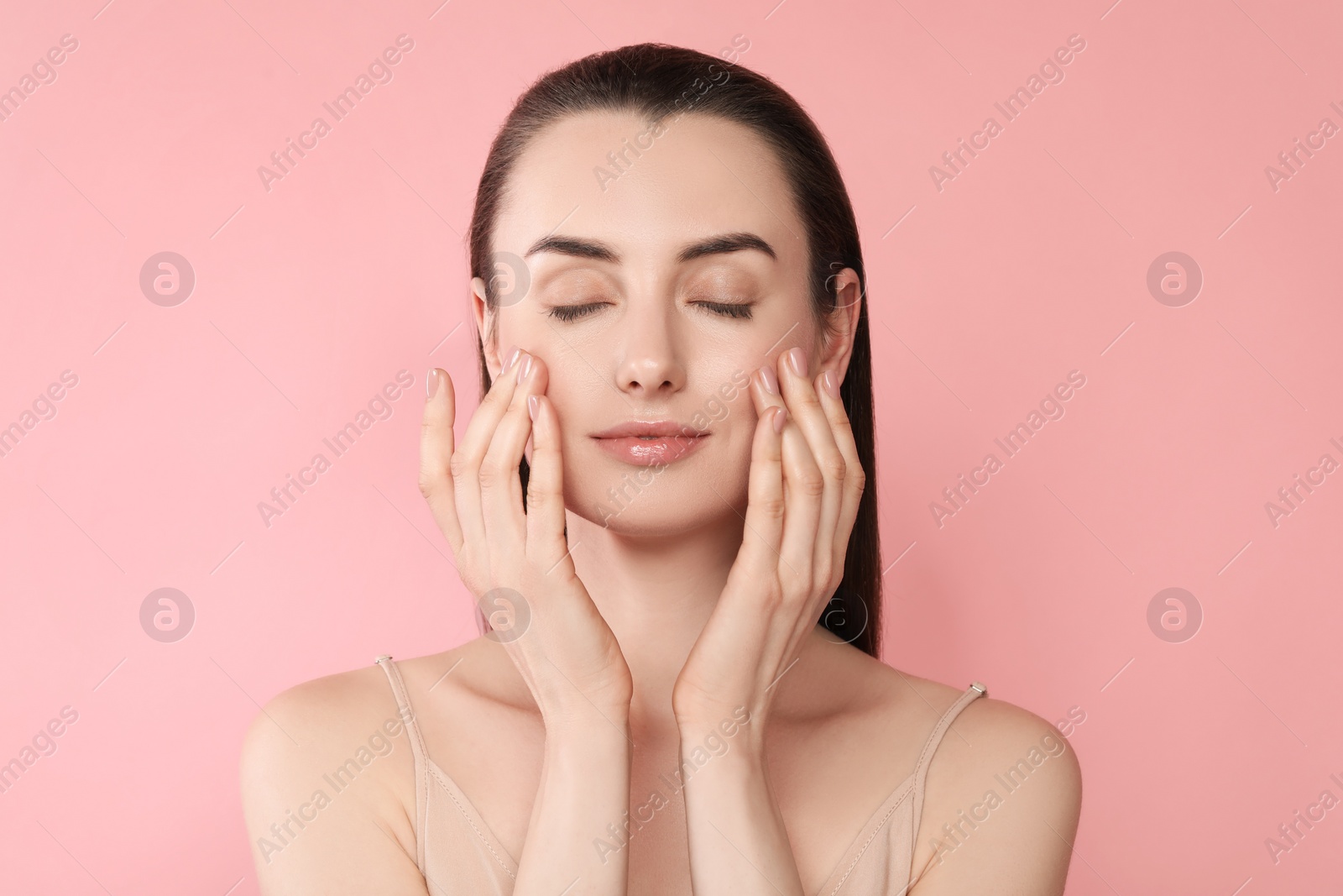 Photo of Portrait of beautiful young woman on pink background