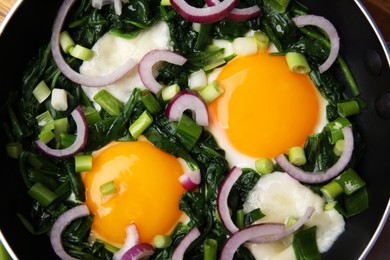 Tasty green Shakshouka in frying pan, top view