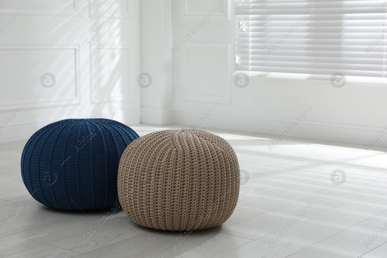 Photo of Different stylish poufs in room, space for text