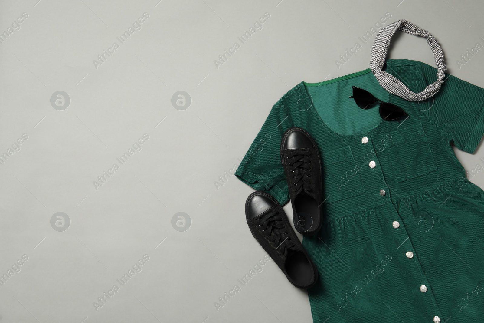 Photo of Flat lay composition with stylish green dress on grey background. Space for text