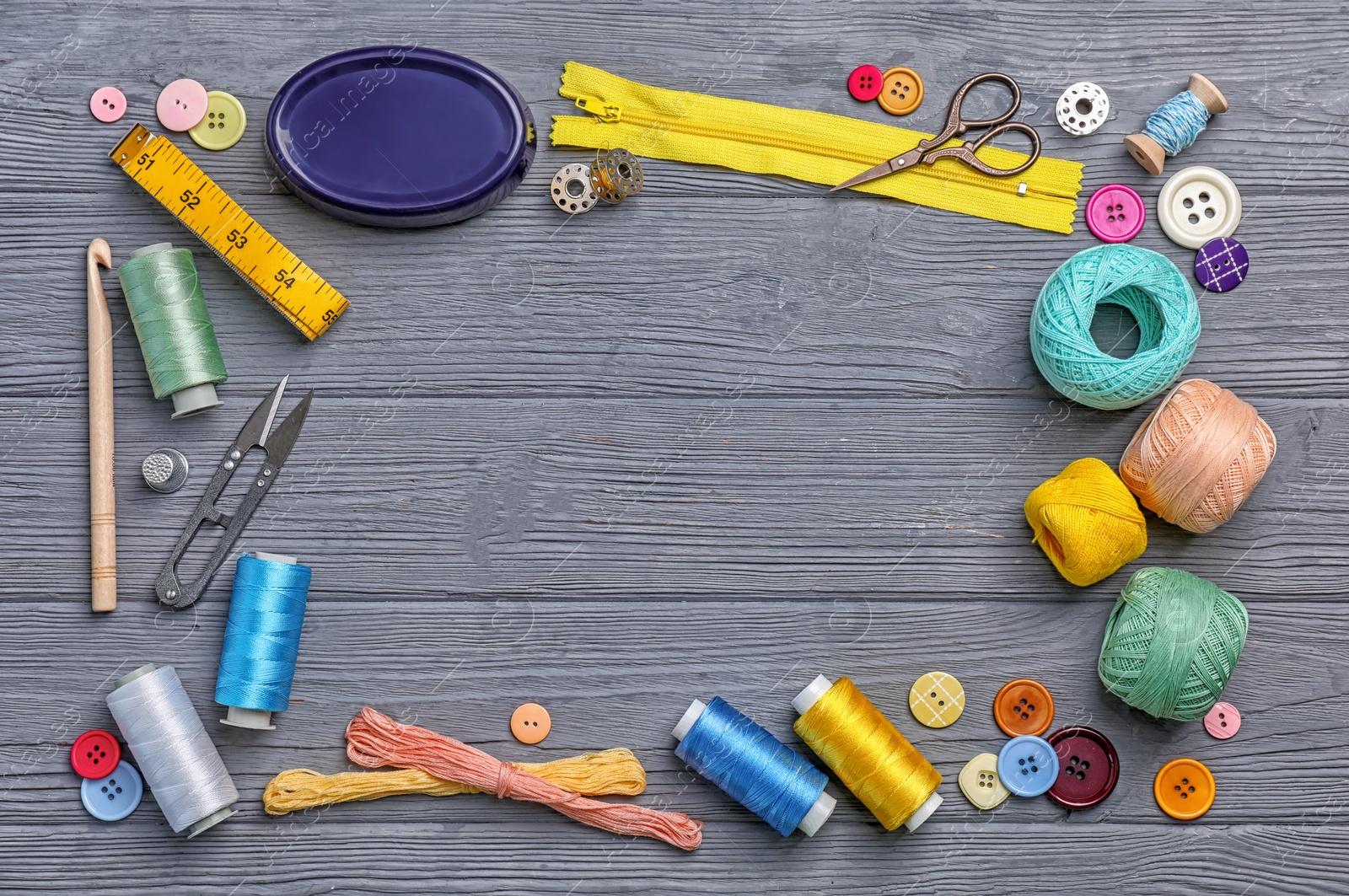 Photo of Flat lay composition with sewing threads and accessories on wooden background