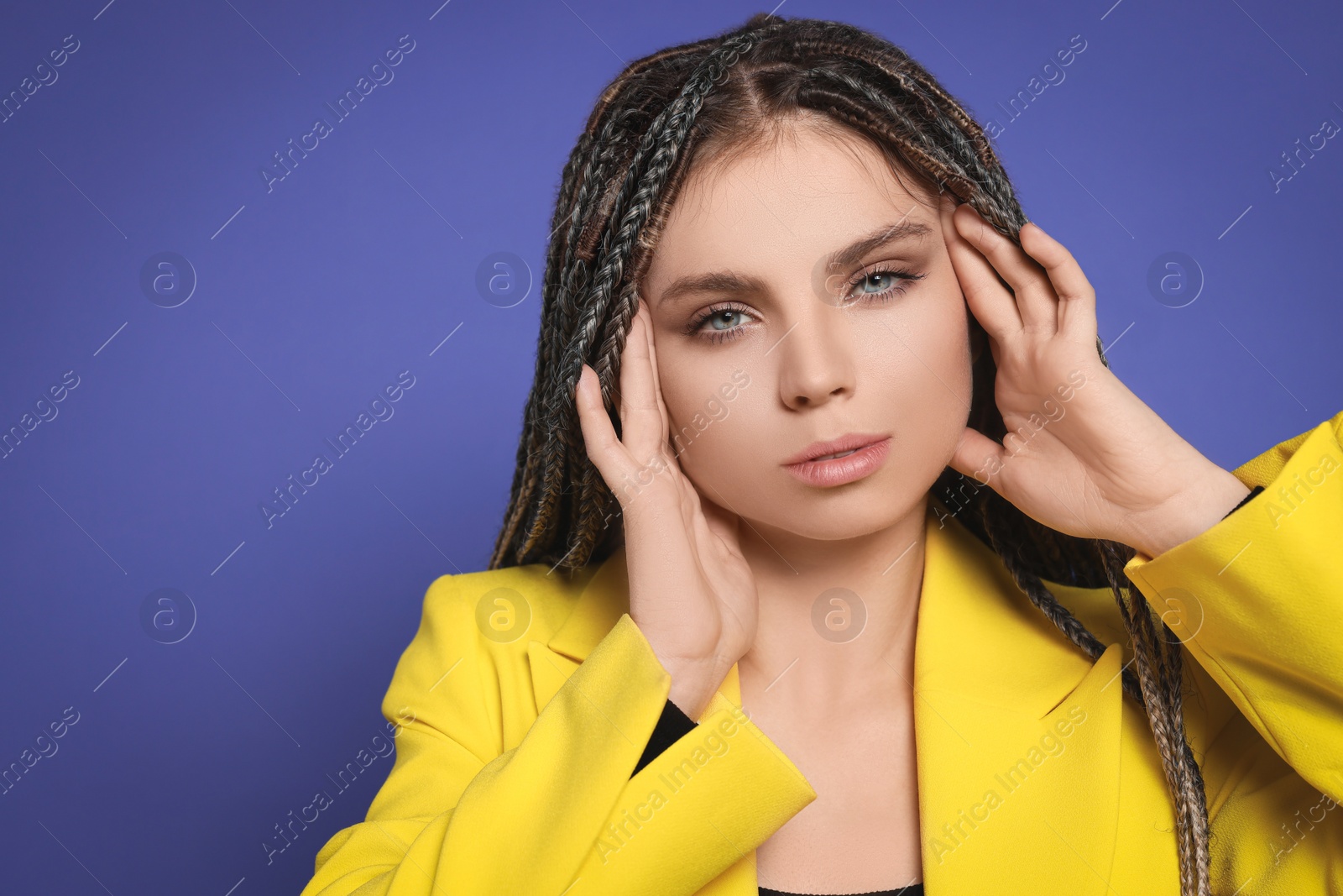 Photo of Beautiful woman with long african braids on purple background, space for text