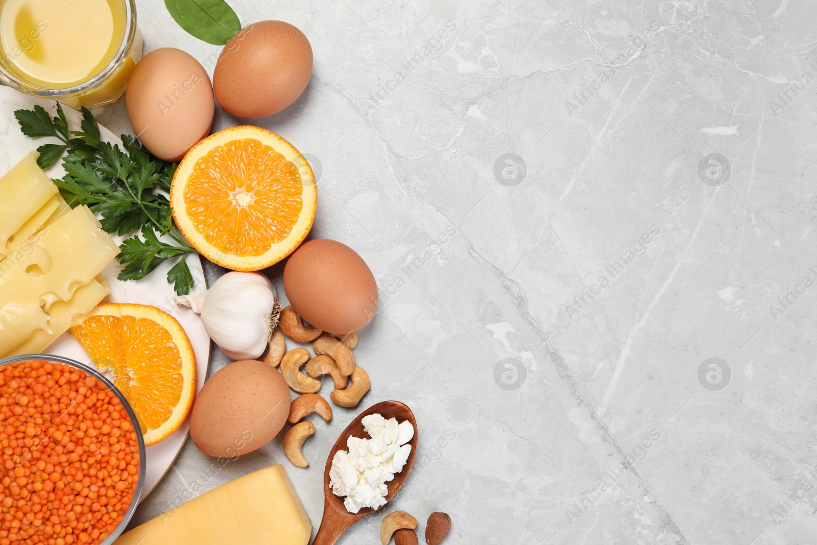 Photo of Set of natural food high in calcium on grey marble table, flat lay. Space for text