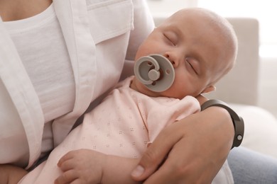 Photo of Mother with her cute sleeping baby at home, closeup