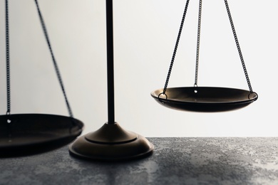 Scales of justice on table, closeup. Law concept