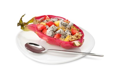 Yummy pitahaya boat with mango, granola and strawberry near spoon on white background