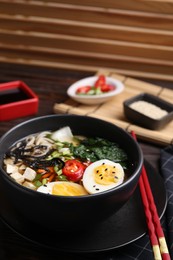 Photo of Delicious vegetarian ramen served on table, closeup. Noodle soup