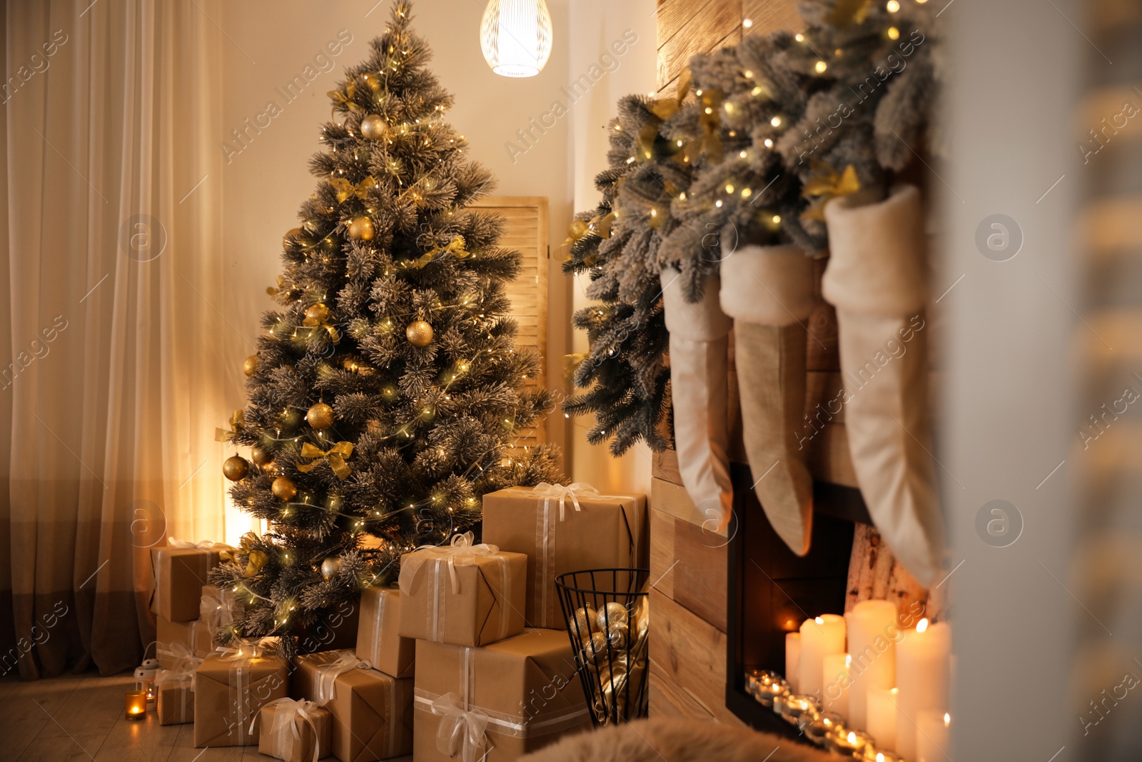 Photo of Stylish room interior with beautiful Christmas tree and gift boxes