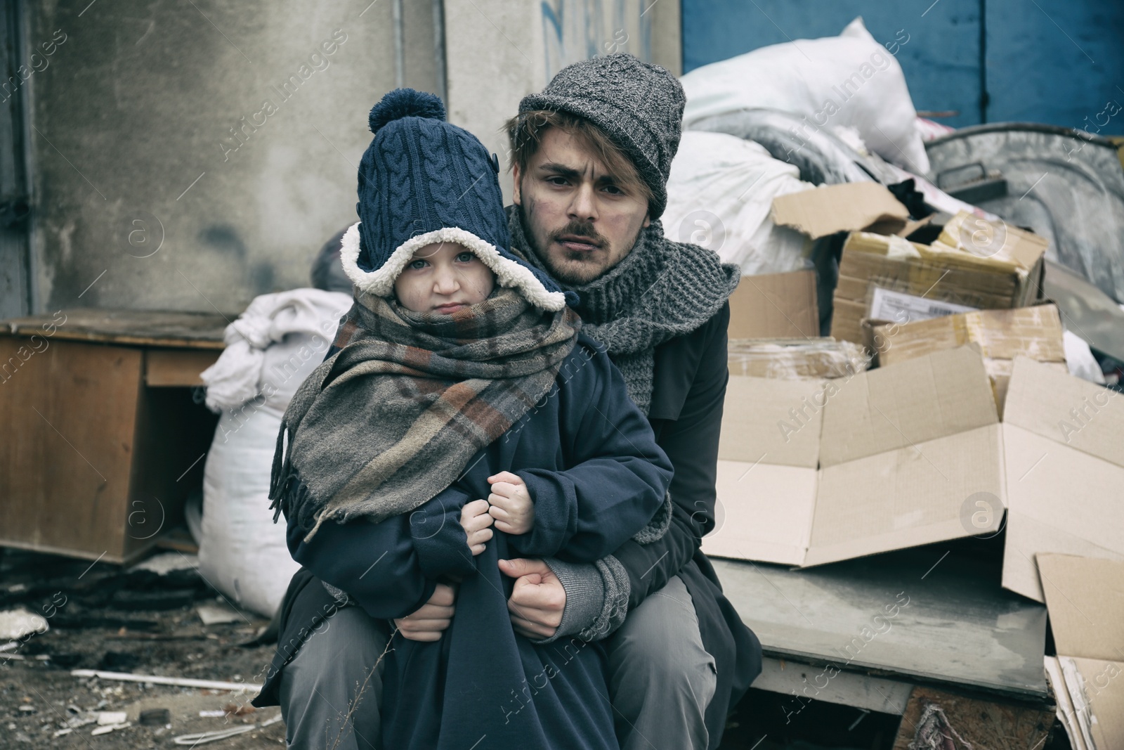 Photo of Poor father and child near garbage at dump