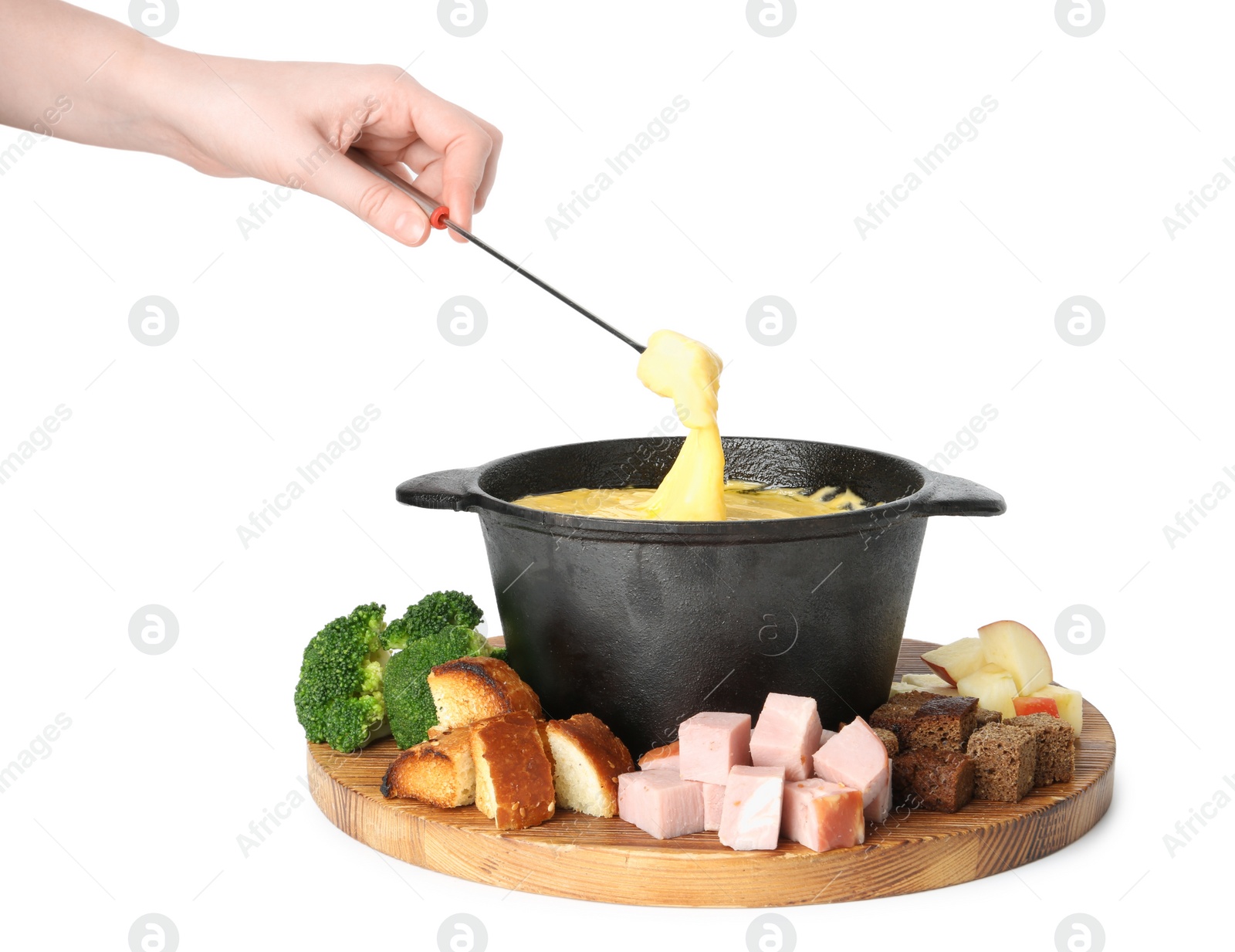 Photo of Woman dipping piece of ham into fondue pot with tasty melted cheese on white background, closeup