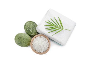 Bowl of sea salt, towels, massage stones and palm leaf isolated on white, top view. Spa treatment
