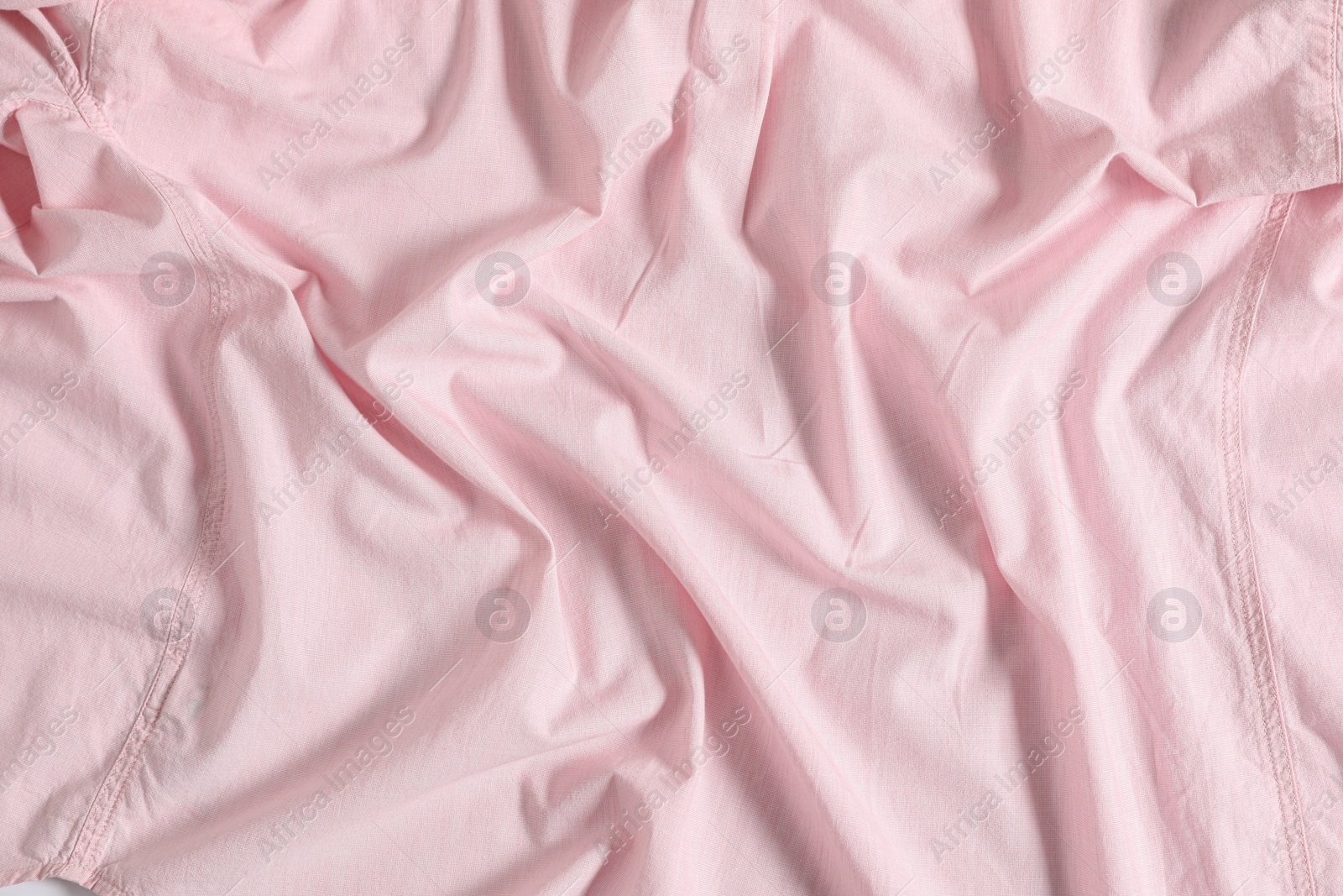 Photo of Crumpled pink fabric as background, top view