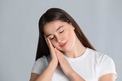 Photo of Portrait of young woman on light background