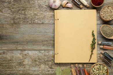 Photo of Blank recipe book and different ingredients on old wooden table, flat lay. Space for text