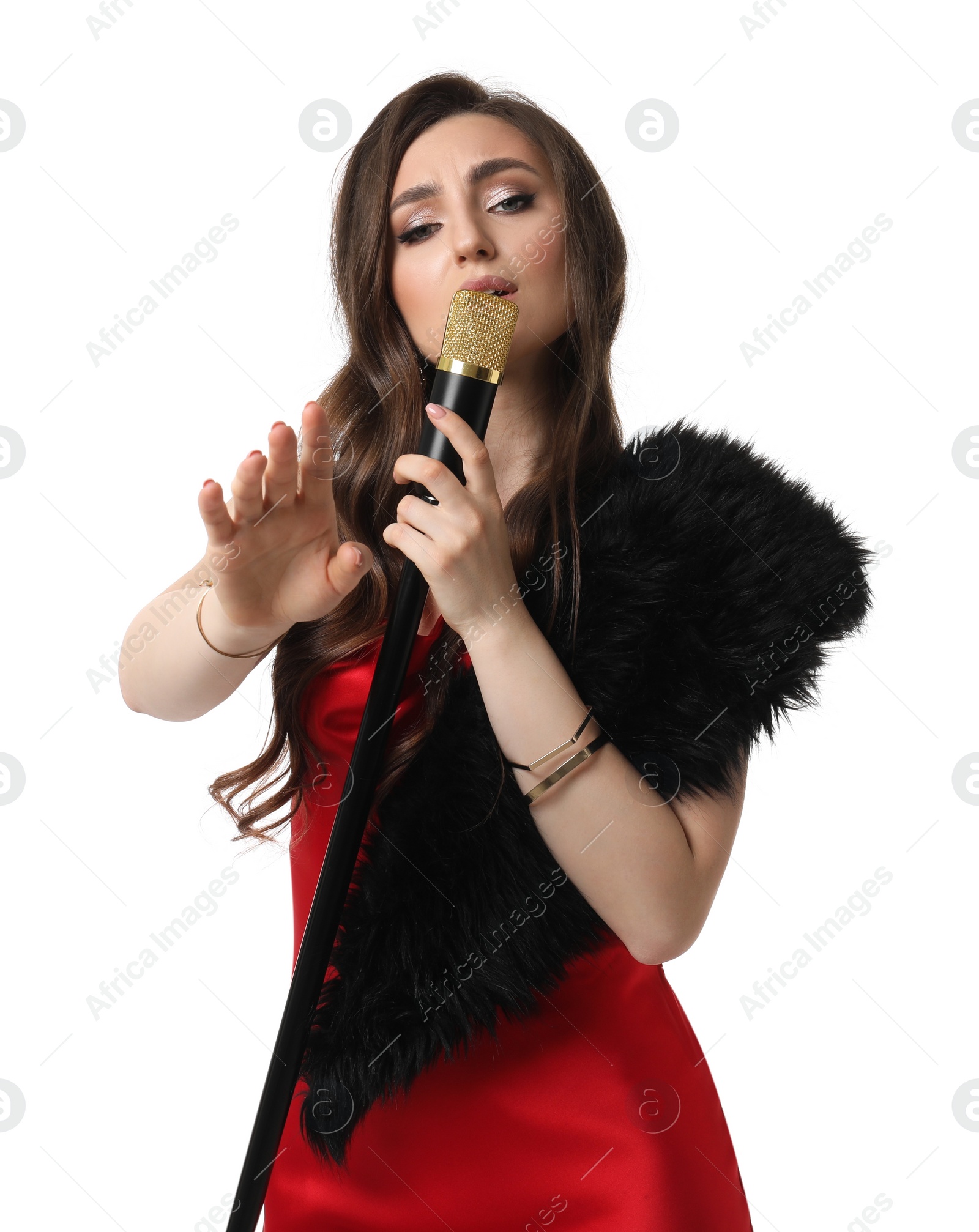 Photo of Beautiful young woman in stylish red dress with microphone singing on white background