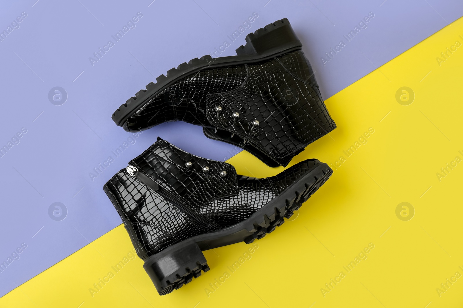 Photo of Pair of stylish ankle boots on color background, top view