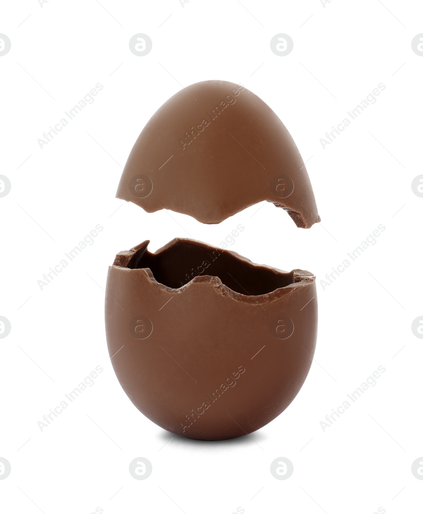 Image of Broken milk chocolate egg on white background