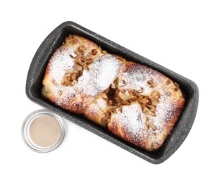 Photo of Delicious cake in baking pan and dry yeast on white background, top view
