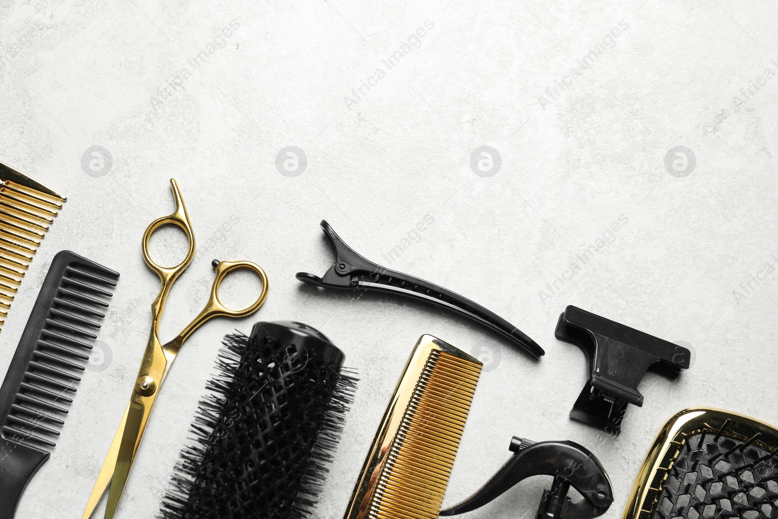 Photo of Hairdressing tools on light background, flat lay. Space for text