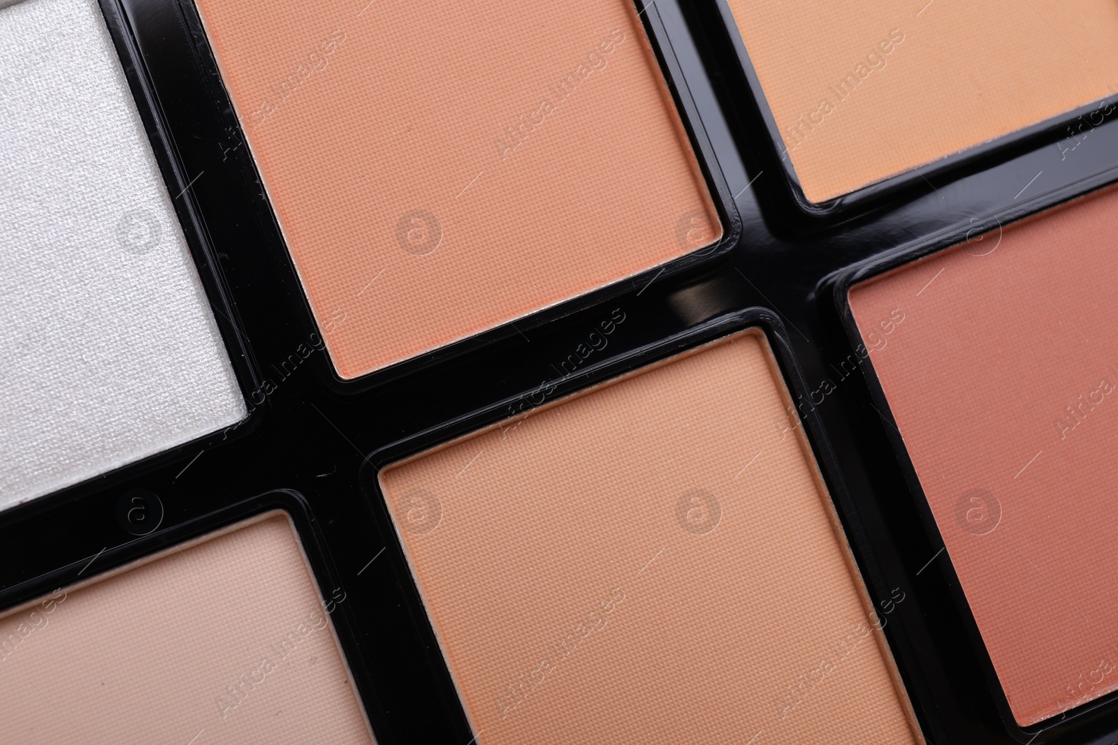 Photo of Colorful contouring palette as background, closeup. Professional cosmetic product