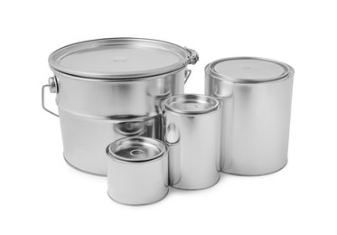 Photo of New metal paint cans and bucket on white background