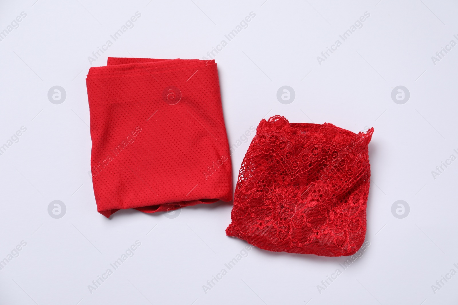 Photo of Stylish folded red women's underwear on white background, flat lay