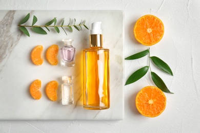 Beautiful composition with perfume and fruits on light background, flat lay