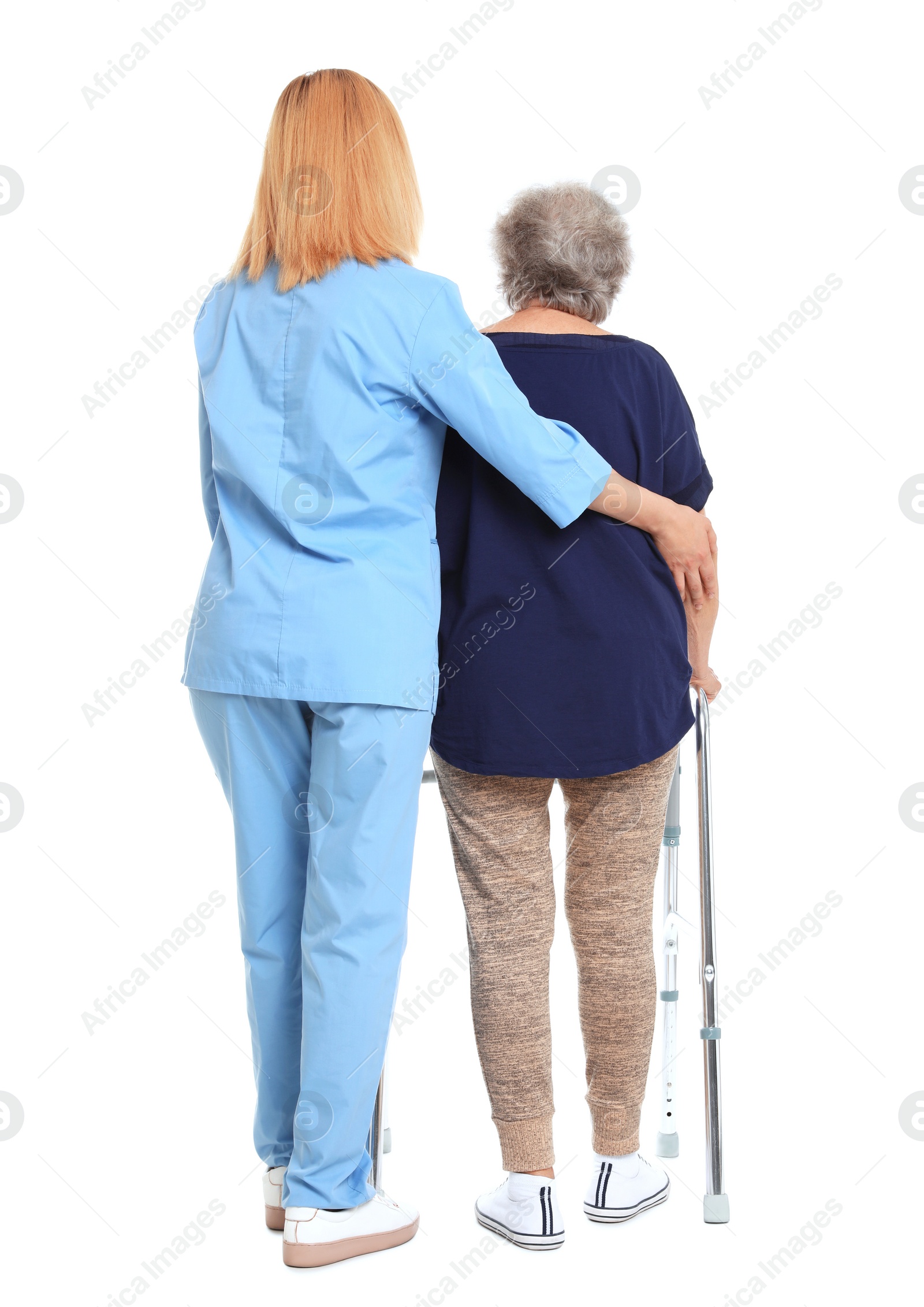 Photo of Caretaker helping elderly woman with walking frame on white background