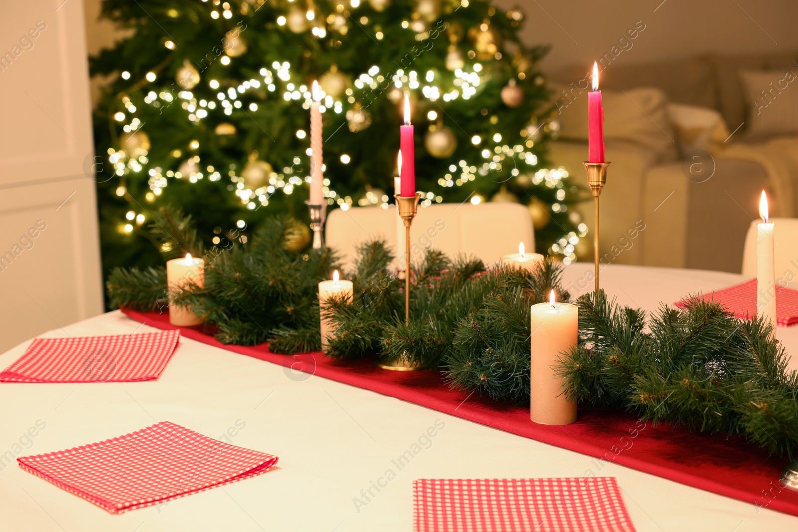 Photo of Red napkins and beautiful Christmas decor indoors. Interior design