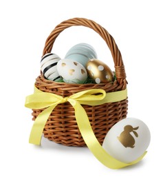 Photo of Easter basket and painted eggs on white background