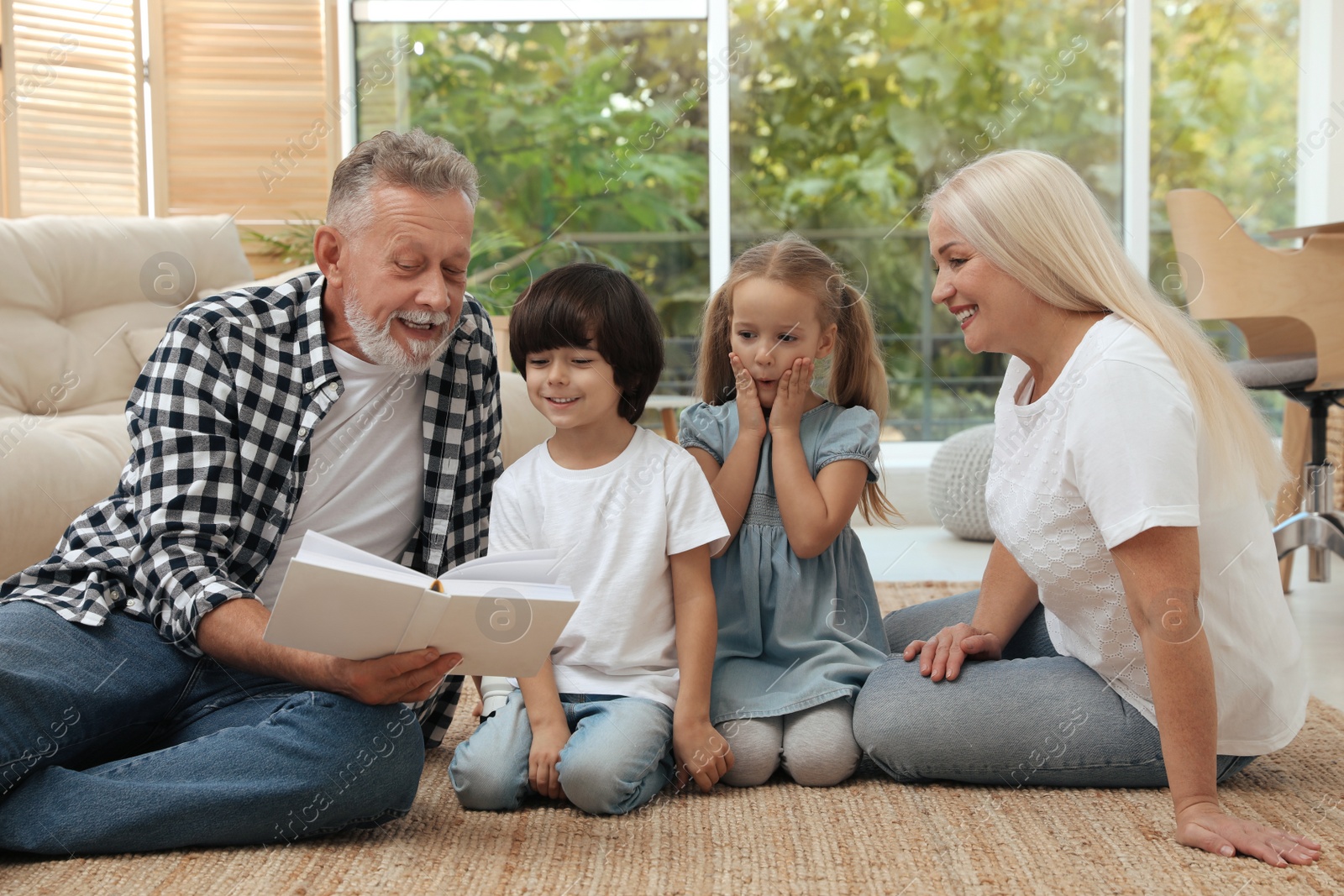 Photo of Grandparents spending time with their grandchildren at home