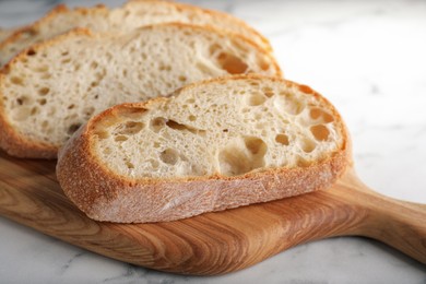 Photo of Freshly baked sodawater bread on wooden board, closeup