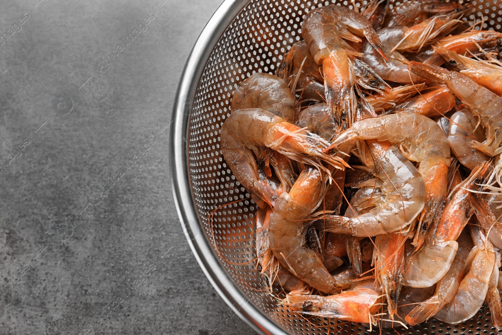 Photo of Colander with fresh shrimps, closeup