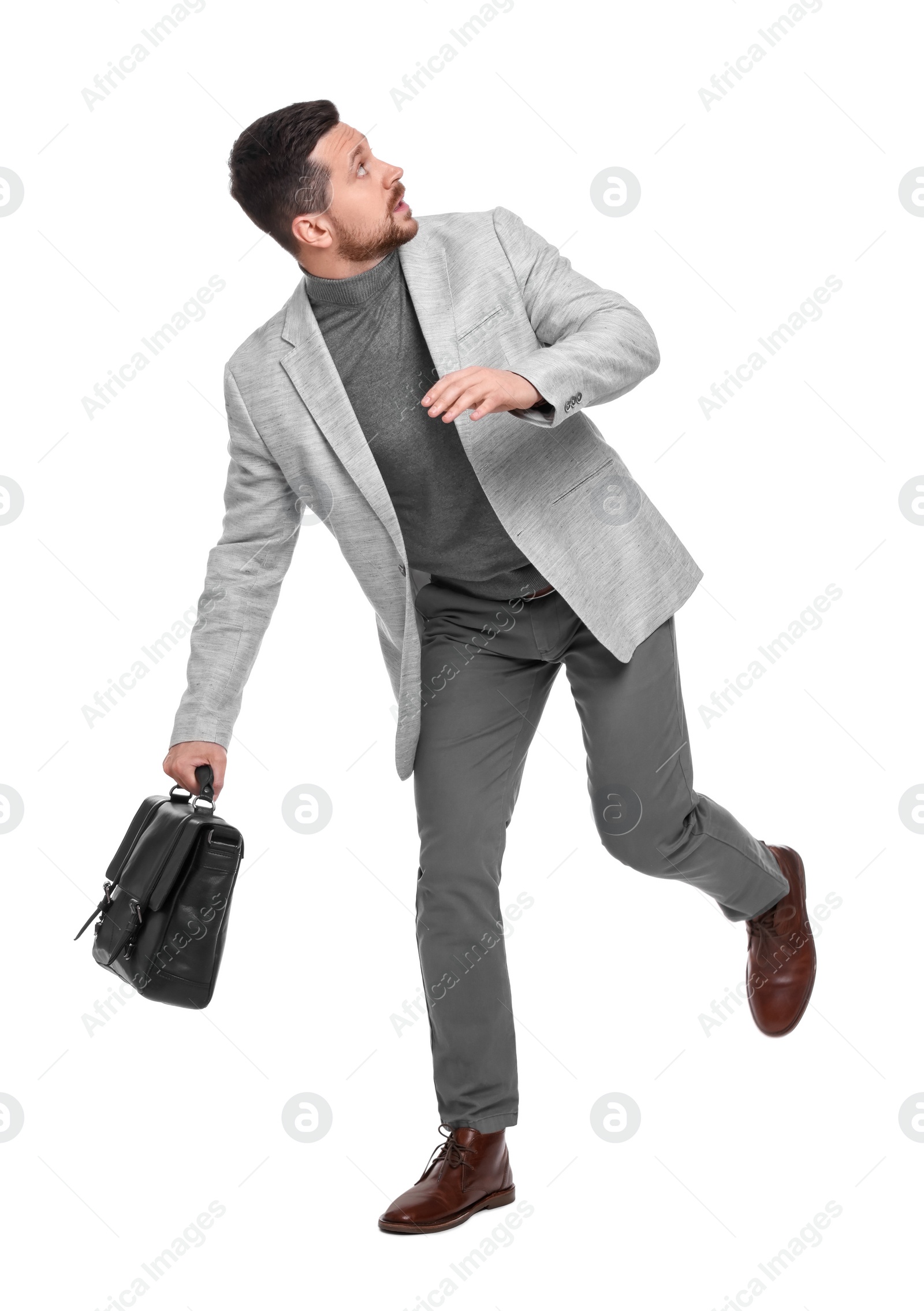 Photo of Handsome bearded businessman with briefcase on white background