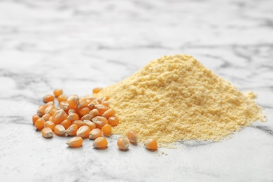 Pile of corn flour and kernels on table