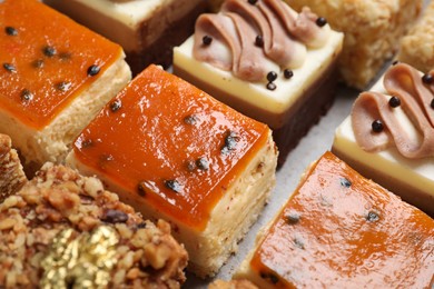 Photo of Pieces of different delicious cakes on table, closeup