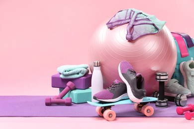 Photo of Many different sports equipment on pink background, space for text