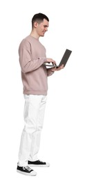 Photo of Handsome young man with laptop on white background