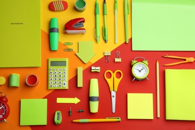 Photo of Different bright school stationery on color background, flat lay