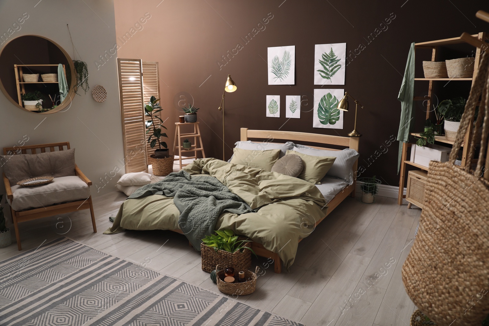 Photo of Stylish room interior with large bed and floral pictures