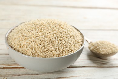 Photo of White sesame seeds on wooden table, closeup