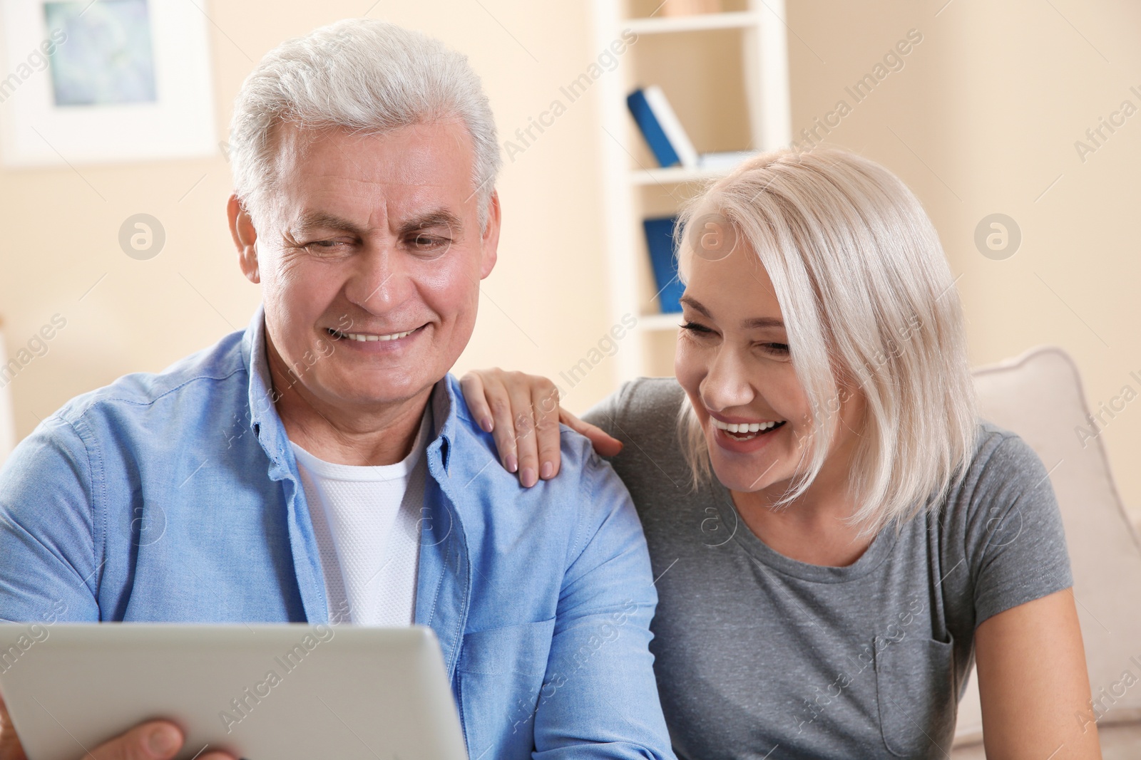 Photo of Mature couple using video chat on tablet at home