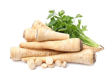 Photo of Raw parsley roots and bunch of fresh herb isolated on white