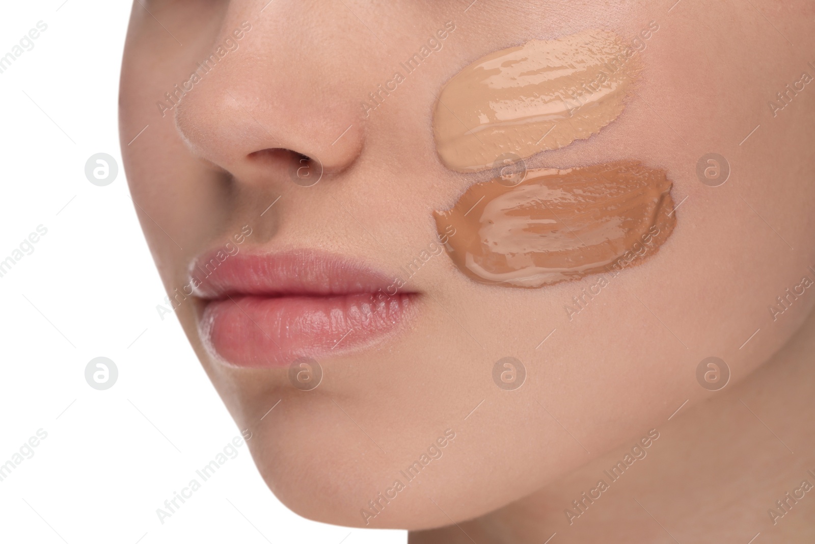 Photo of Teenage girl with swatches of foundation on face against white background, closeup