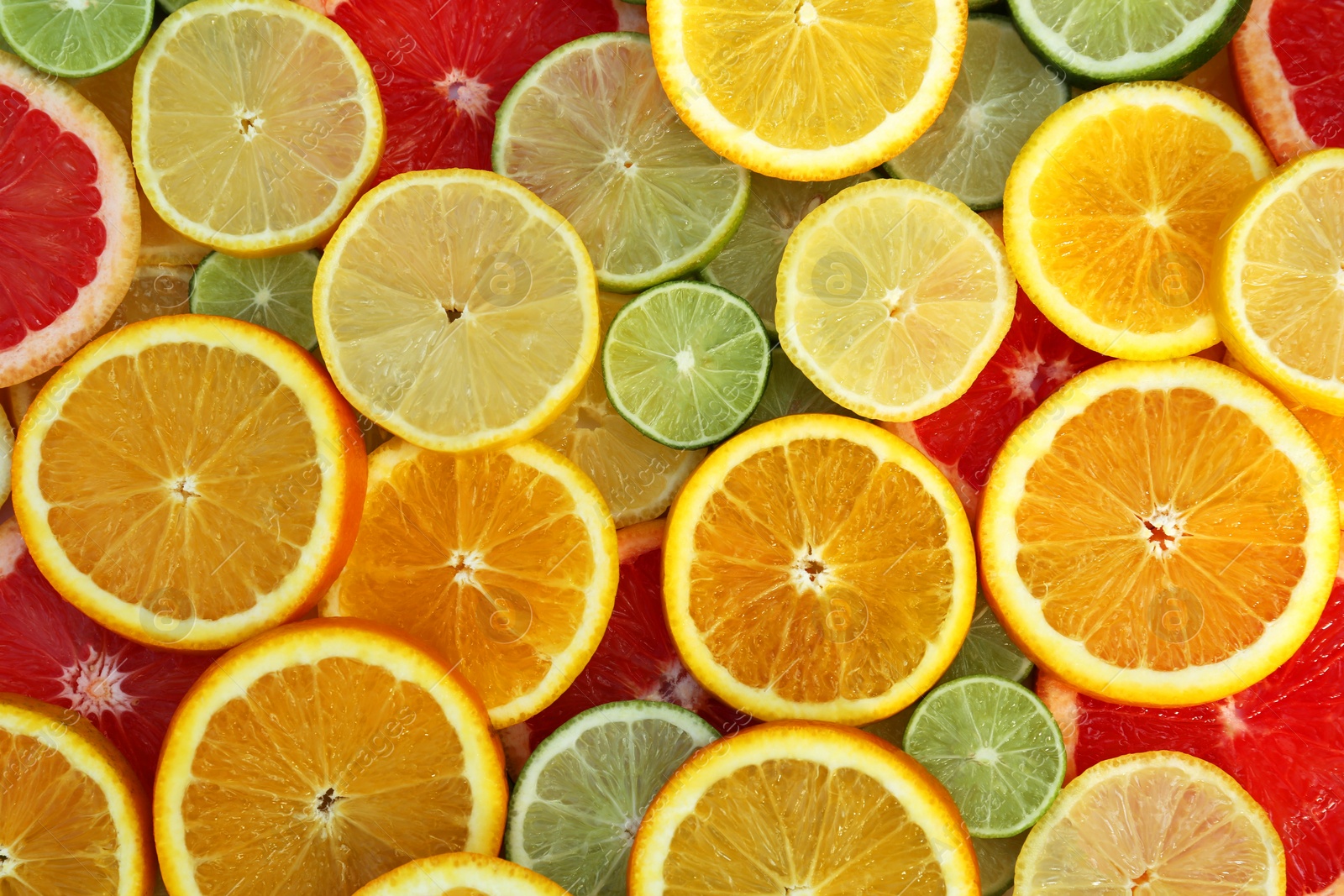 Photo of Different citrus fruits as background, top view