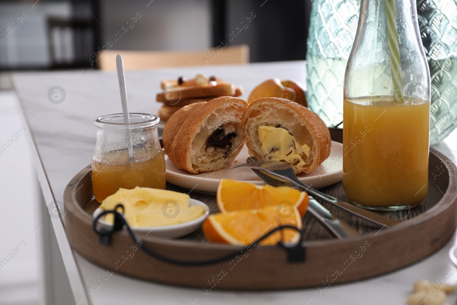 Photo of Tray with tasty breakfast on white table in morning